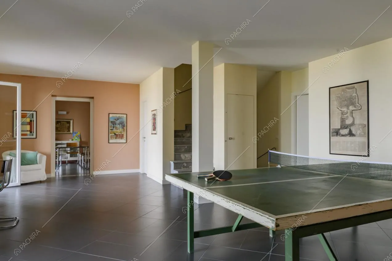 Salotto con tavolo da ping pong e vista sulla sala accanto