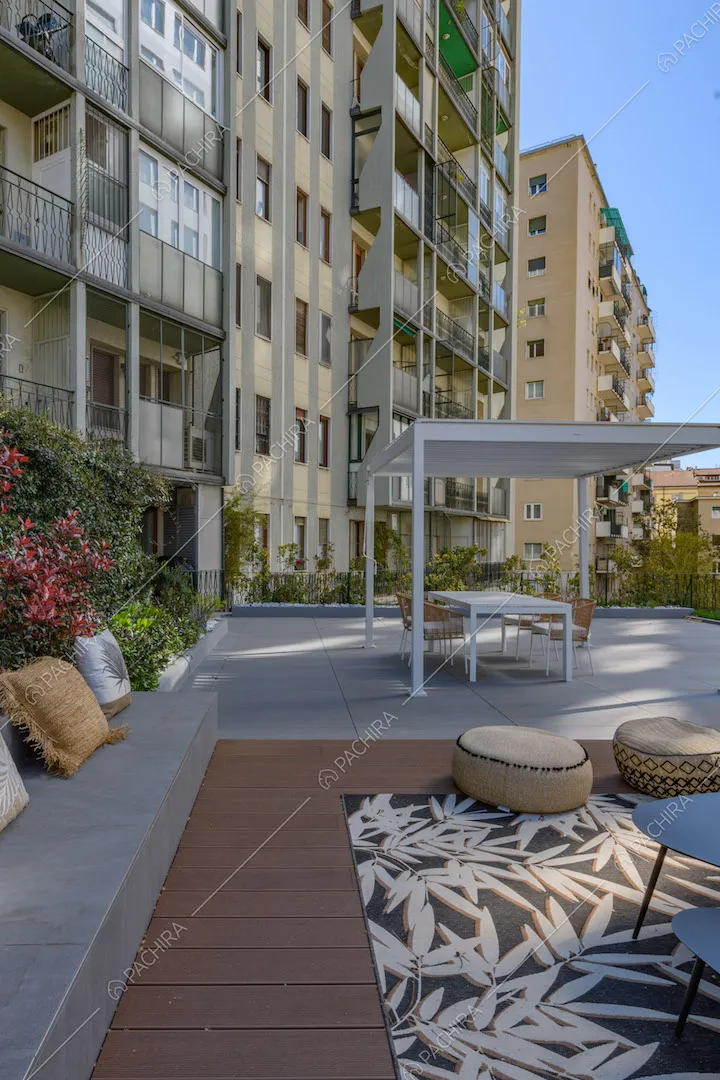 Pavimentazione in parquet sulla terrazza con gazebo e vista sui palazzi circostanti