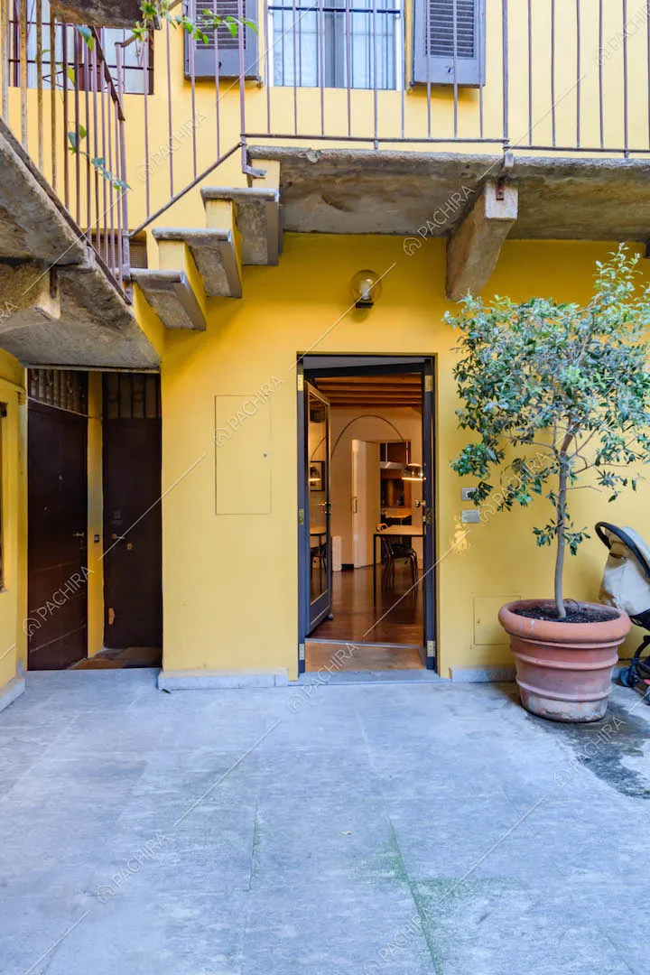 Ingresso della location e vista sugli esterni gialli del condominio