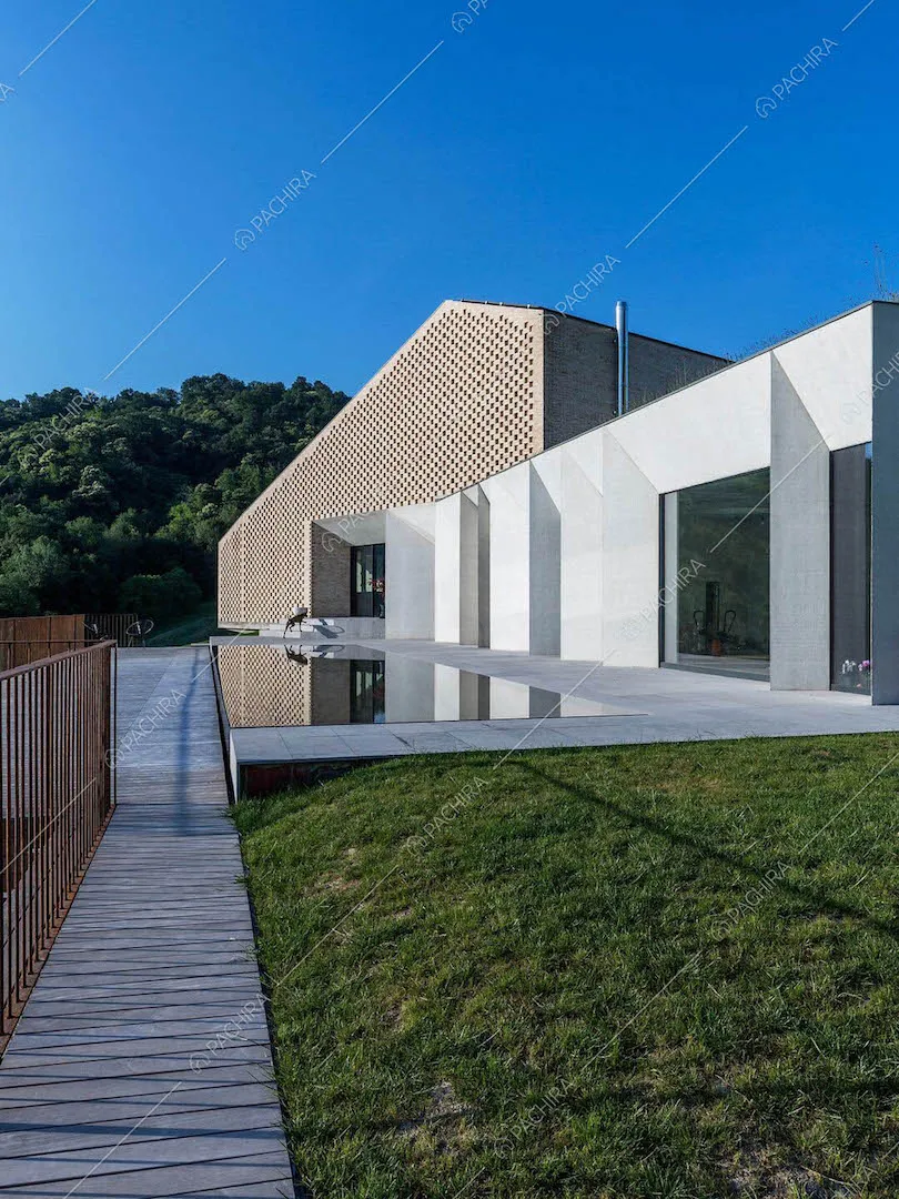 Dal curato giardino della villa, vialetto che conduce alla piscina e all'ingresso